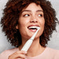 Woman using the wisdom power plus pro clean toothbrush